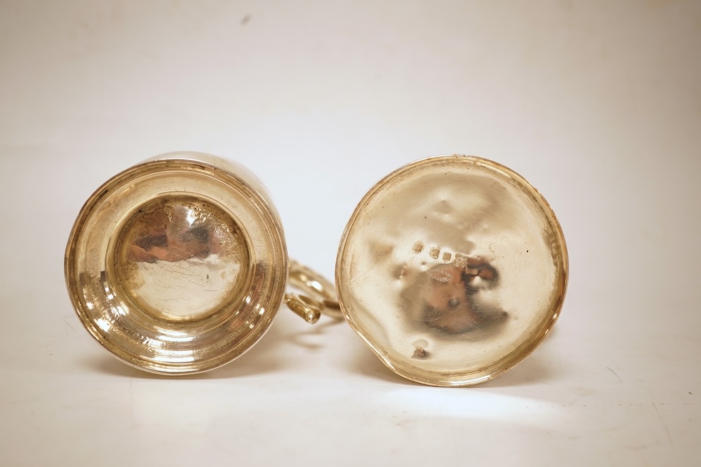 A George III silver baluster mug, Peter & Ann Bateman?, London, 1797, height 10.6cm, together with a late Victorian embossed silver christening mug, Glasgow, 1893, 12.2oz.